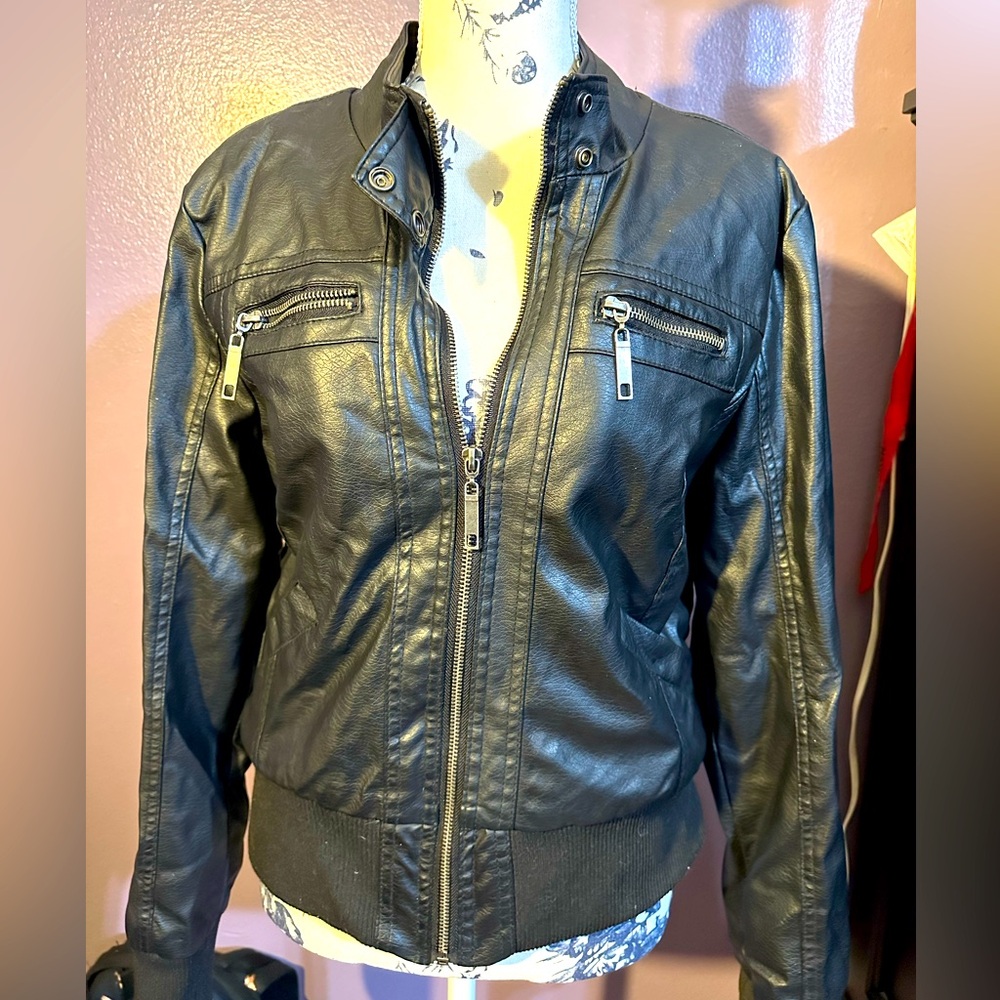 Black faux leather jacket with polyester lining.